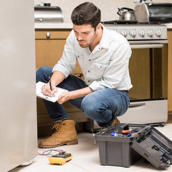 portrait handsome male technician doing work report broken fridge home kitchen 22